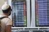 Passengers look at the monitor displaying delayed flights at Ben Gurion airport, near Tel Aviv, Israel, Monday, March 27, 2023. THE CANADIAN PRESS/AP-Oren Ziv
