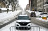 An Ottawa Police officer sits in their cruiser on Wellington Street below Parliament Hill in Ottawa on Friday, Jan. 27, 2023. The criminal trial of two 