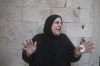 A Palestinian woman reacts during her relative's funeral, killed by an Israeli airstrike, in Rafah, Gaza Strip, Friday, Oct. 13, 2023. (AP Photo/Hatem Ali)