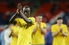 Australia's Awer Mabil applauds to supporters at the end of the international friendly soccer match between England and Australia at Wembley Stadium, London, Friday, Oct. 13, 2023. (AP Photo/David Cliff)