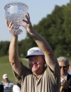 FILE -Andy Bean holds up the trophy after winning the Champions Tour's Greater Hickory Classic golf tournament at Rock Barn Golf and Spa's Jones Course in Conover N.C., Sunday, Oct. 1, 2006. Andy Bean, an 11-time PGA Tour winner and three times a runner-up in the majors, died Saturday, Oct. 14, 2023 after complications from a double lung replacement surgery, the PGA Tour said. He was 70 (AP Photo/Nathan W. Armes, File)