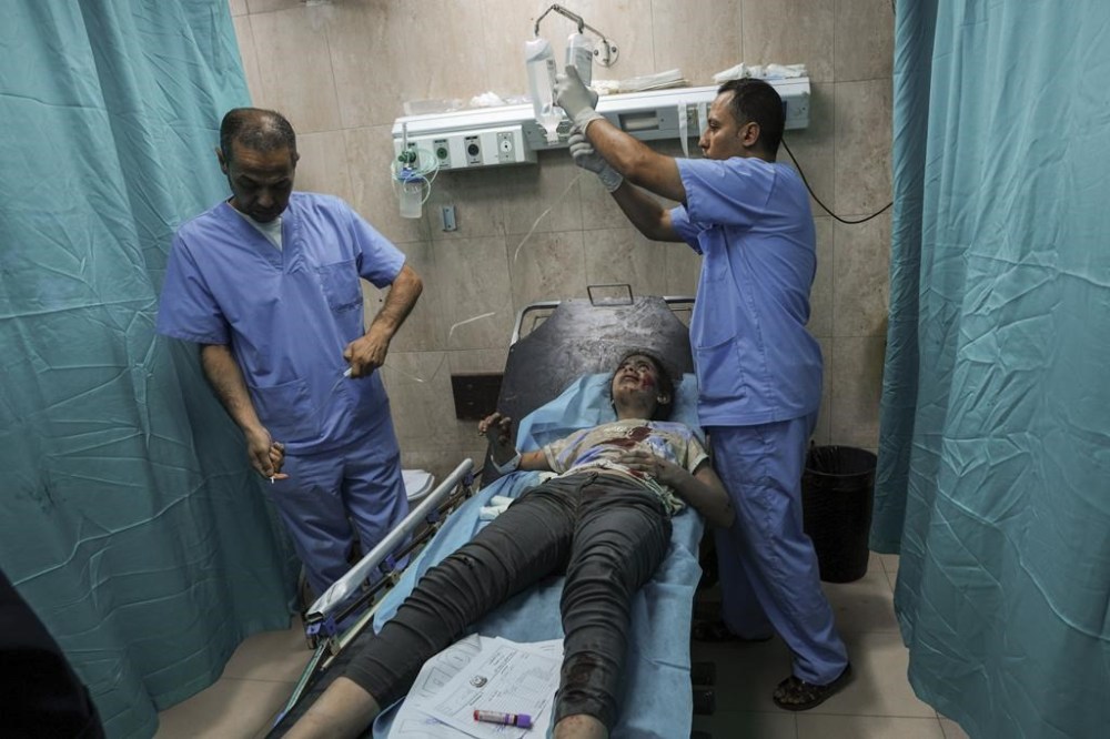 A Palestinian girl wounded during an Israeli airstrike receives medical treatment at al-Aqsa hospital in Deir el-Balah, central Gaza Strip, Sunday, Oct. 15, 2023. (AP Photo/Adel Hana)