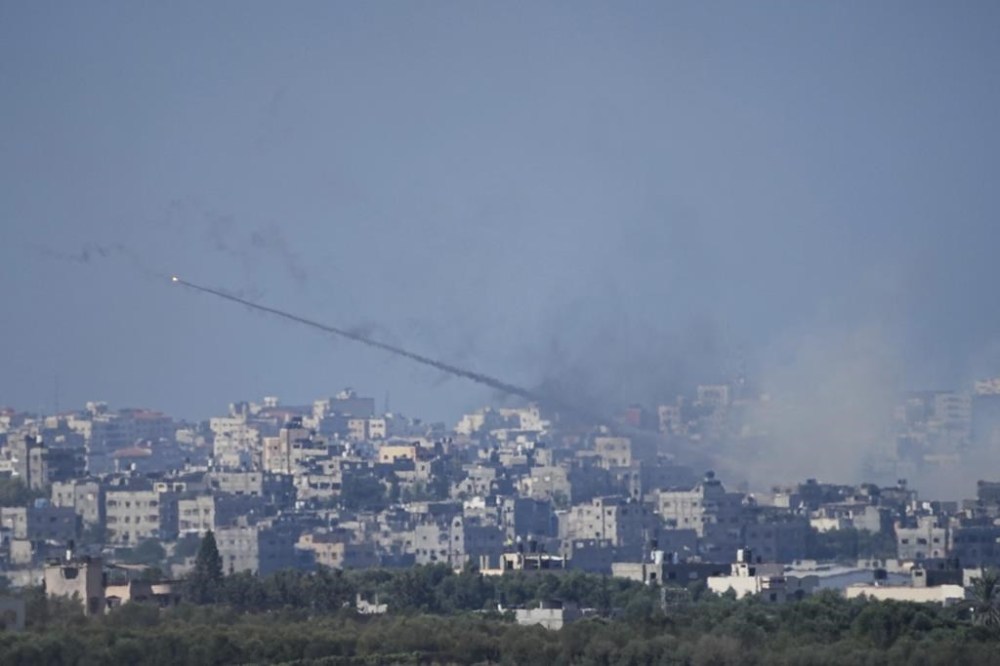 Rockets are fired toward Israel from the Gaza Strip, as seen from southern Israel, Sunday, Oct. 15, 2023. Israel has been striking targets throughout Gaza since a bloody, cross-border attack by Hamas militants killed over 1,300 and captured many Israelis on Oct. 7. (AP Photo/Ariel Schalit)