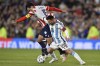 Argentina's Lionel Messi battles for the ball with Paraguay's Gustavo Gomez during a qualifying soccer match for the FIFA World Cup 2026 at the Monumental stadium in Buenos Aires, Argentina, Thursday, Oct. 12, 2023. (AP Photo/Gustavo Garello)