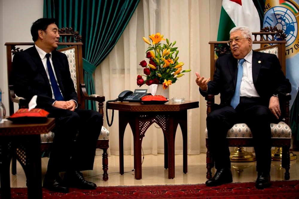 FILE - Palestinian President Mahmoud Abbas, right, speaks with Chinese Middle East envoy Zhai Jun, during a meeting at the President's office in the West Bank city of Ramallah, Dec. 7, 2019. Its Middle East envoy, Zhai Jun, talked to Palestinian and Egyptian officials by phone this past week, calling for an immediate cease-fire and humanitarian support for the Palestinian people. Zhai also phoned Israeli officials to say China “has no selfish interests on the Palestinian issue but has always stood on the side of peace, on the side of fairness and justice.” He said “China is willing to work with the international community to promote peace and encourage talks.” (AP Photo/Majdi Mohammed, File)