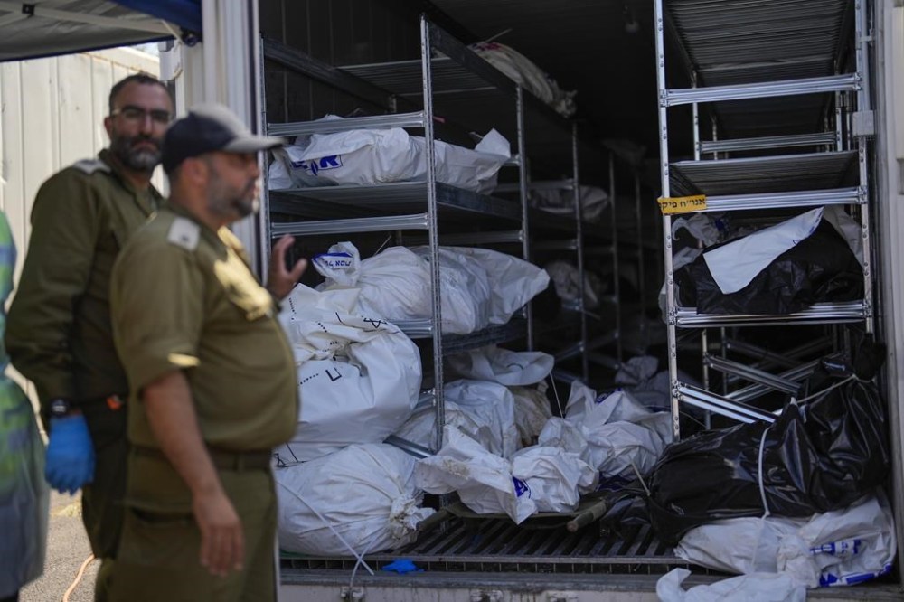The bodies of Israelis killed in an unprecedented Hamas attack are gathered for identification at a military base in Ramla, Israel, Friday, Oct. 13, 2023. Israeli officials say 1,300 people were killed when Hamas militants burst across the border last Saturday and went on a deadly rampage through Israeli border towns, villages, army bases and a music festival. (AP Photo/Francisco Seco)