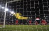 Croatia's Dominik Livakovic jumps to make a save from a free kick by Wales' Harry Wilson, not pictured, during the Euro 2024 Qualifying Group D match between Wales and Croatia at the Cardiff City Stadium in Wales, Sunday, Oct. 15, 2023. (Nick Potts/PA via AP)