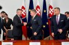 Hlas-Social Democracy party chairman Peter Pellegrini, left, and Smer-Social Democracy party chairman Robert Fico, center, shake hands after they signed a coalition agreement to form a new government in Bratislava, Slovakia, Monday, Oct. 16, 2023. At right is Slovak National Party chairman Andrej Danko. (Vaclav Salek/CTK via AP)
