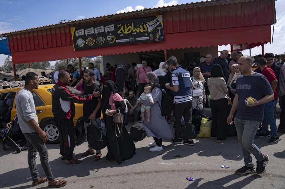 Palestinians wait to cross into Egypt at the Rafah border crossing in the Gaza Strip, on Monday, Oct. 16, 2023. (AP Photo/Fatima Shbair)