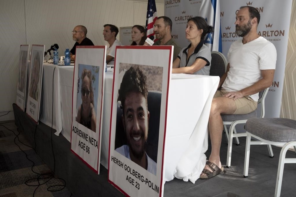FILE - Relatives of U.S. citizens that are missing since Saturday's surprise attack by Hamas militants near the Gaza border, attend a news conference on Oct. 10, 2023 in Tel Aviv, Israel. Seated from left: Jonathan Dekel-Chen, father of Sagui Dekel-Chen (35) from Nahal Oz; Ruby Chen, father of Itay Chen, 19, a soldier in the armored corps; Ayala Neta, daughter, and Nahal Neta, son of Adrienne Neta, 66, a nurse living in Kibbitz Be'eri; Rachel Goldberg, mother of Hersh Goldberg-Polin, 23, and Jonathan Polin, Hersh's father. Hersh was last seen when Hamas militants loaded him into the back of a pickup truck with other hostages abducted from a trance music festival in the western Negev Desert on Oct. 7. His mother, Rachel Goldberg, expects to see him again. (AP Photo/Maya Alleruzzo, File)