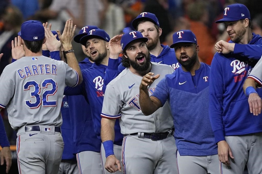 The Texas Rangers celebrate after Game 2 of the baseball AL Championship Series against the Houston Astros Monday, Oct. 16, 2023, in Houston. The Rangers won 5-4 to take a 2-0 lead in the series. (AP Photo/David J. Phillip)