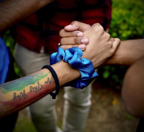 LGBTQ community supporters and members hold hands as they wait for the Supreme Court verdict on petitions that seek the legalization of same-sex marriage, in New Delhi, India, Tuesday, Oct. 17, 2023. Homosexuality has long carried a stigma in India’s traditional society, even though there has been a shift in attitudes toward same-sex couples in recent years. (AP Photo/Manish Swarup)