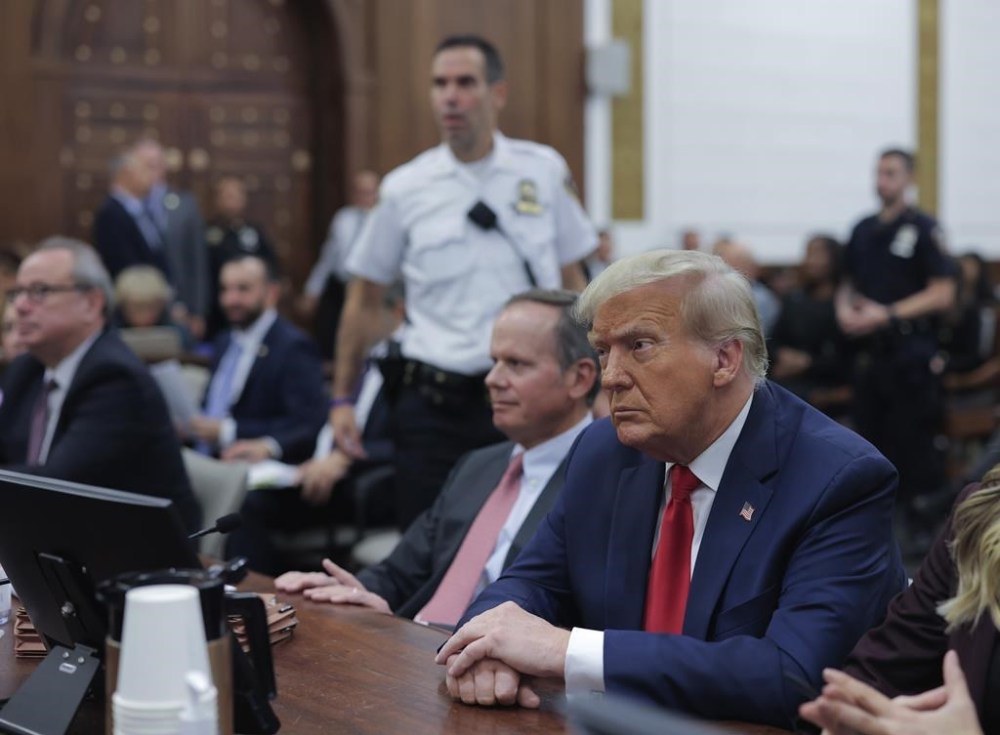 Former President Donald Trump sits in the courtroom with his legal team before the continuation of his civil business fraud trial at New York Supreme Court, Tuesday, Oct. 17, 2023, in New York. (Andrew Kelly/Pool Photo via AP)