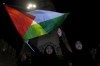 Demonstrators chant slogans as they hold a Palestinian flag during a protest in solidarity with the Palestinian people in Gaza, at Martyrs' Square in downtown Beirut, Lebanon, Tuesday, Oct. 17, 2023. (AP Photo/Bilal Hussein)