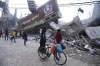 An Ontario man says his father, who's stuck in Gaza, is on the brink of starvation along with other relatives and is calling on the international community to push Israel to allow humanitarian aid into the enclave immediately. Palestinians walk by the destroyed building of Al Nuseirat Bakery in an Israeli airstrike Nusseirat refugee camp Gaza Strip, Wednesday, Oct. 18, 2023. THE CANADIAN PRESS/AP-Hatem Moussa