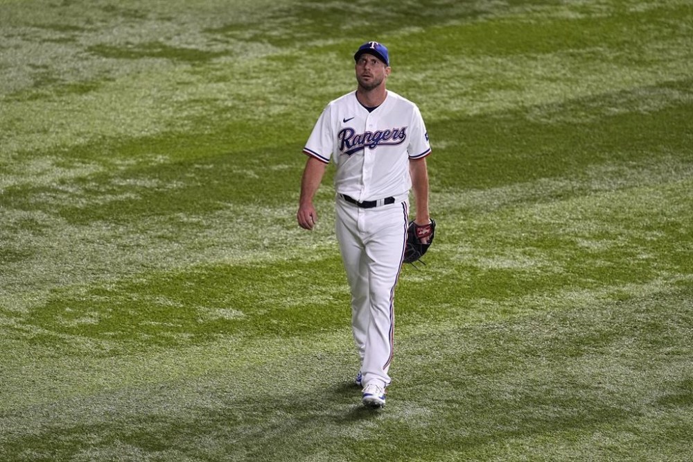 Texas Rangers starting pitcher Max Scherzer walks out to the bullpen before Game 3 of the baseball American League Championship Series against the Houston Astros Wednesday, Oct. 18, 2023, in Arlington, Texas. (AP Photo/Tony Gutierrez)