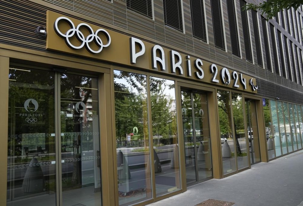 FILE - The entrance of the headquarters of the Paris 2024 Olympics Games is pictured Sunday, Aug. 13, 2023 in Saint-Denis, outside Paris. Organizers of next year's Paris Olympics say their headquarters have again been visited by French financial prosecutors who are investigating suspicions of favoritism, conflicts of interest and misuse of funds in the awarding of Olympic contracts. (AP Photo/Michel Euler, File)