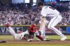 Philadelphia Phillies' Bryce Harper scores past Arizona Diamondbacks relief pitcher Ryan Thompson on a wild pitch during the seventh inning in Game 3 of the baseball NL Championship Series in Phoenix, Thursday, Oct. 19, 2023. (AP Photo/Brynn Anderson)
