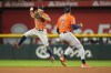 Houston Astros second baseman Jose Altuve (27) throws to first for the out after fielding a ground ball by Texas Rangers' Josh Jung during the seventh inning in Game 4 of the baseball American League Championship Series Thursday, Oct. 19, 2023, in Arlington, Texas. (AP Photo/Julio Cortez)
