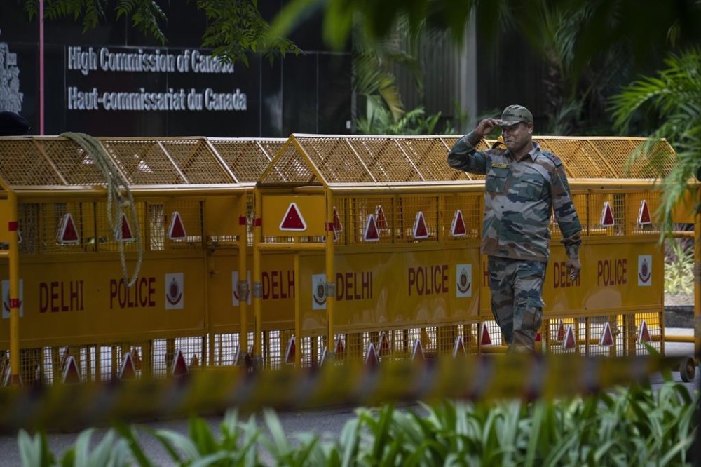 An Indian paramilitary soldier stands guard next to a police barricade outside the Canadian High Commission in New Delhi, India, Tuesday, Sept. 19, 2023.India is defending its diplomatic actions a day after Ottawa announced it had pulled most of its envoys from the country over what it called a precedent-setting diplomatic threat. THE CANADIAN PRESS/AP/Altaf Qadri