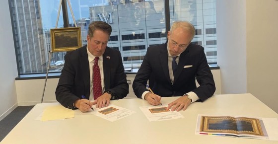 FBI Special Agent David White, left, and Bernd Ebert, a curator at the Alte Pinakothek in Munich, sign documents returning an 18th-century painting by Vienna-born artist Johann Franz Nepomuk Lauterery. (Claire Savage / The Associated Press)