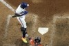 Texas Rangers' Adolis Garcia, left, is hit by a pitch as Houston Astros catcher Martin Maldonado reaches for the pitch during the eighth inning in Game 5 of the baseball American League Championship Series Friday, Oct. 20, 2023, in Arlington, Texas. (AP Photo/Godofredo A. Vásquez)