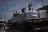 Trucks with humanitarian aid for the Gaza Strip enter from Egypt in Rafah on Saturday, Oct. 21, 2023. A Canadian man trapped in Gaza says the first truckloads of aid let into the enclave today since the latest Israel-Hamas war began two weeks ago will barely make a dent to the humanitarian crisis Palestinians are experiencing all around him.THE CANADIAN PRESS/AP/Fatima Shbair