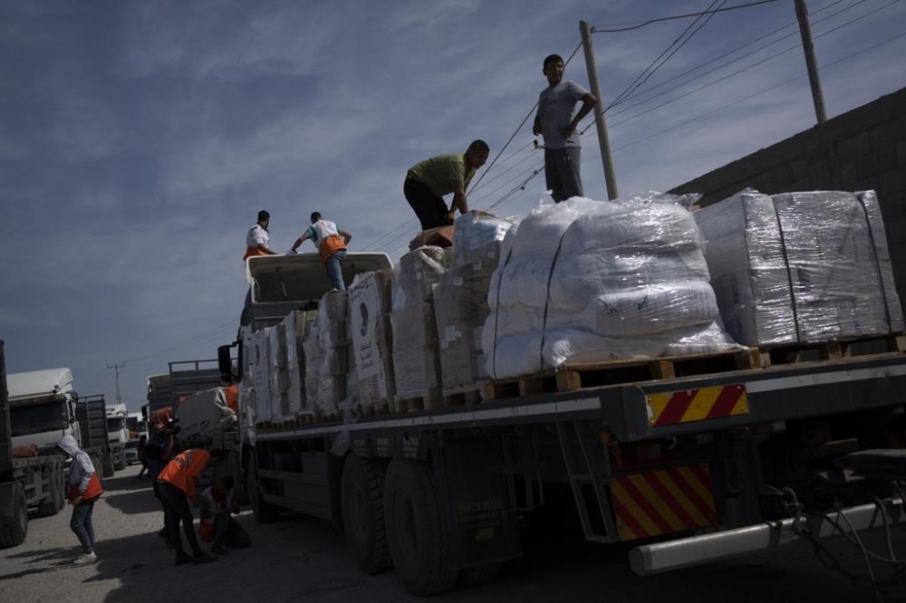 Trucks with humanitarian aid for the Gaza Strip enter from Egypt in Rafah on Saturday, Oct. 21, 2023. A Canadian man trapped in Gaza says the first truckloads of aid let into the enclave today since the latest Israel-Hamas war began two weeks ago will barely make a dent to the humanitarian crisis Palestinians are experiencing all around him.THE CANADIAN PRESS/AP/Fatima Shbair