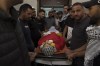 Mourners take the last look at the body of Sohaib al-Soos, 15, during his funeral in the West Bank city of Ramallah, Saturday, Oct. 21, 2023. Al-Soos was killed during an Israeli army raid in the town of Betunia last Friday, the Palestinian ministry of health said. (AP Photo/Nasser Nasser)