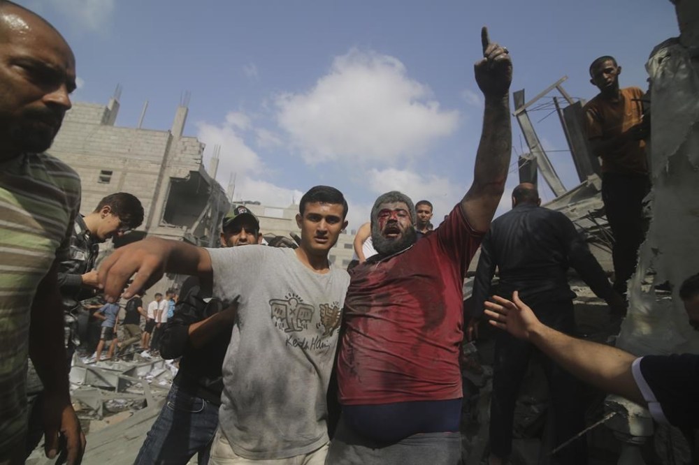 Palestinians are evacuated from buildings hit in the Israeli bombardment of the Gaza Strip in Rafah, Sunday, Oct. 22, 2023. (AP Photo/Hatem Ali)