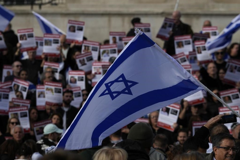 Israeli supports show placards with the faces and names of people believed to be taken hostage and held in Gaza, during a protest in Trafalgar Square, London, Sunday, Oct. 22, 2023. They are demanding the release of all hostages allegedly taken by the militant group Hamas. (AP Photo/Frank Augstein)