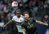 Vancouver Whitecaps' Javain Brown, left, and Los Angeles FC's Ryan Hollingshead vie for the ball during the second half of an MLS soccer match, in Vancouver, B.C., Saturday, Oct. 21, 2023. THE CANADIAN PRESS/Darryl Dyck