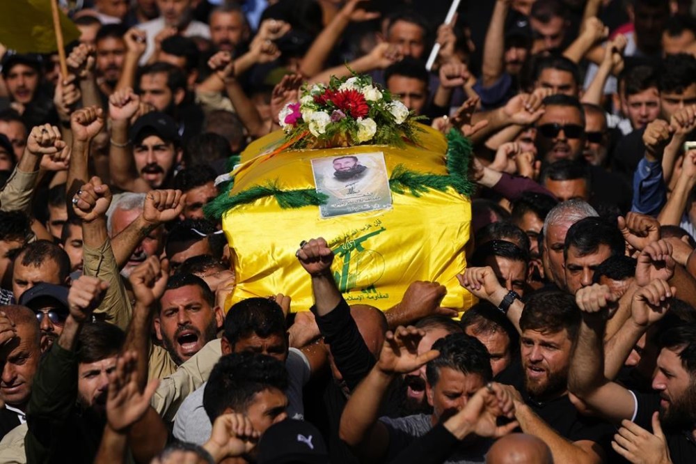 People carry the coffin of Hezbollah fighter, Bilal Nemr Rmeiti, who was killed by Israeli shelling, during his funeral procession in Majadel village, south Lebanon, Sunday, Oct. 22, 2023. (AP Photo/Hassan Ammar)