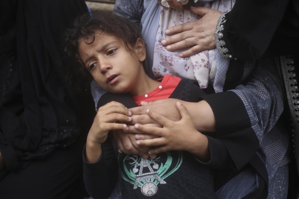 Palestinians mourn their relatives killed in the Israeli bombardment of the Gaza Strip in Rafah, Monday, Oct. 23, 2023. (AP Photo/Hatem Ali)