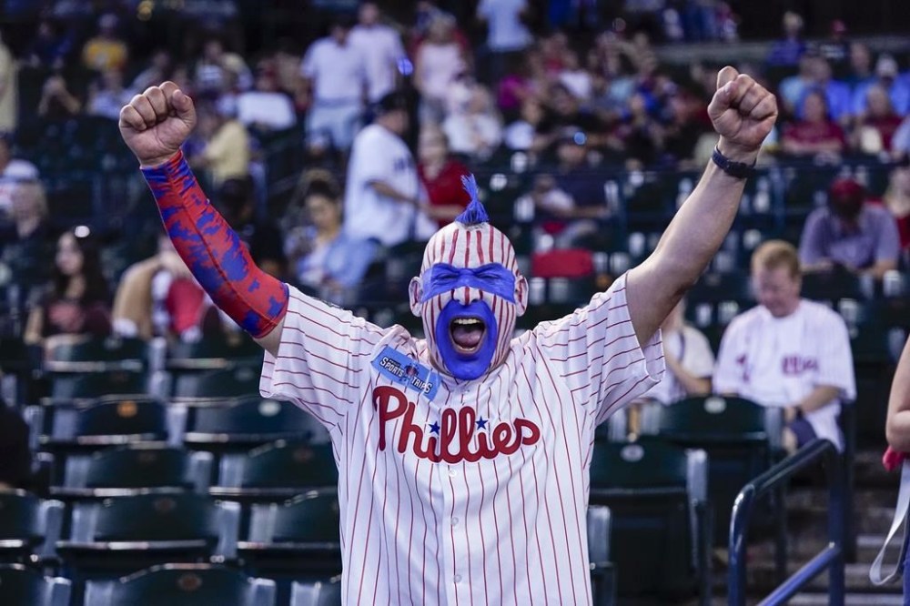 A Philadelphia Phillies fan celebrates before Game 3 of the baseball NL Championship Series against the Arizona Diamondbacks in Phoenix, Thursday, Oct. 19, 2023. (AP Photo/Ross D. Franklin)