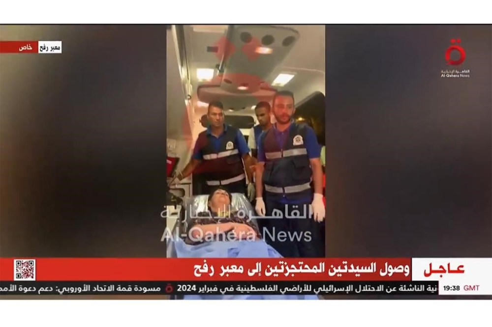 In this image taken from video released by al-Qahera News, Nurit Cooper, 79, rests in an ambulance at the Rafah border crossing, Monday, Oct. 23, 2023, after being released by Hamas militants. (al-Qahera News via AP)