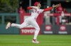 Philadelphia Phillies shortstop Trea Turner can't get a glove on a hit by Arizona Diamondbacks' Corbin Carroll during the fifth inning in Game 6 of the baseball NL Championship Series in Philadelphia Monday, Oct. 23, 2023. (AP Photo/Brynn Anderson)