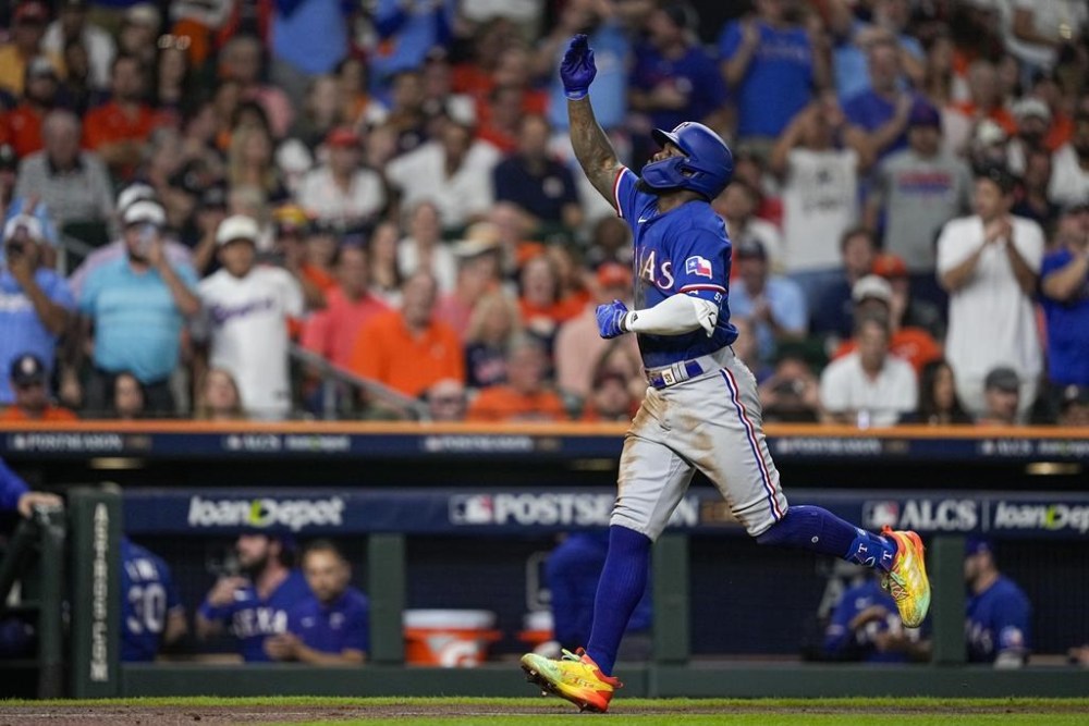 Texas Rangers' Adolis Garcia reacts after hitting a home run during the third inning of Game 6 of the baseball AL Championship Series against the Houston Astros Monday, Oct. 23, 2023, in Houston. (AP Photo/David J. Phillip)