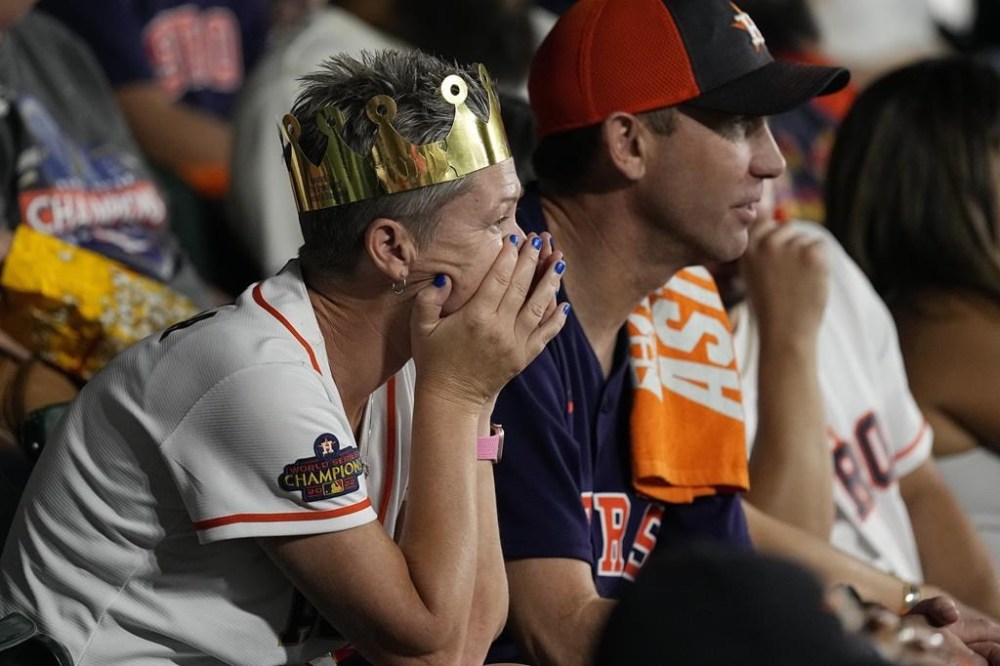 Houston Astros fans react during the eighth inning of Game 6 of the baseball AL Championship Series against the Texas Rangers Monday, Oct. 23, 2023, in Houston. (AP Photo/Tony Gutierrez)