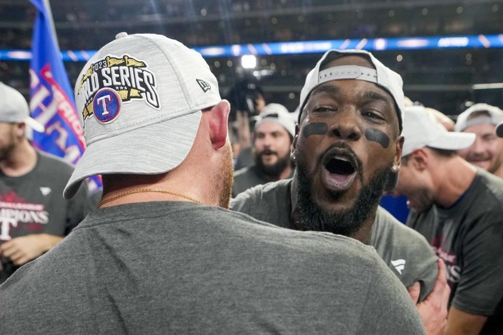 Texas Rangers' Adolis Garcia celebrates after Game 7 of the baseball AL Championship Series against the Houston Astros Monday, Oct. 23, 2023, in Houston. The Rangers won 11-4 to win the series 4-3. (AP Photo/David J. Phillip)