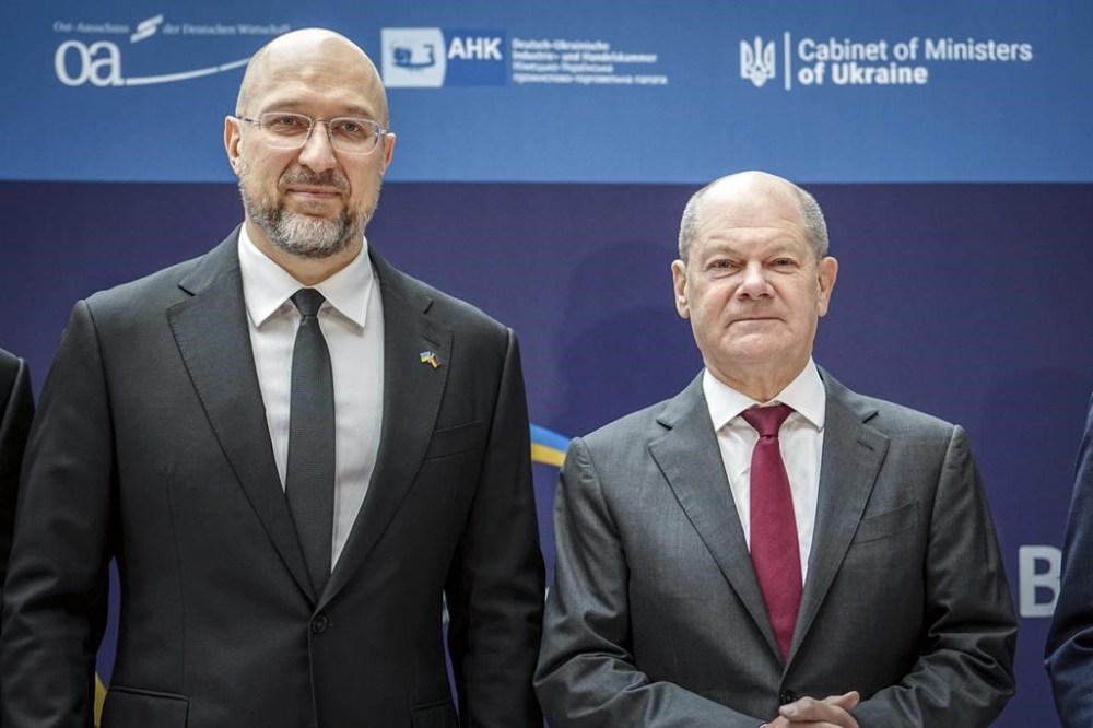 Ukraine's Prime Minister Denys Shmyhal, left, and German Chancellor Olaf Scholz pose for photographers during the 6th German-Ukrainian Business Forum organized by DIHK, the Committee on Eastern European Economic Relations and the German-Ukrainian Chamber of Industry and Commerce (AHK Ukraine), in Berlin, Tuesday, Oct. 24, 2023. (Kay Nietfeld/dpa via AP)