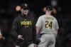 San Diego Padres manager Bob Melvin, left, walks to the dugout after making a pitching change during the ninth inning of the team's baseball game against the San Francisco Giants in San Francisco, Tuesday, Sept. 26, 2023. (AP Photo/Jeff Chiu)