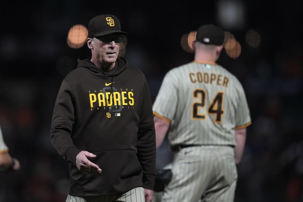 San Diego Padres manager Bob Melvin, left, walks to the dugout after making a pitching change during the ninth inning of the team's baseball game against the San Francisco Giants in San Francisco, Tuesday, Sept. 26, 2023. (AP Photo/Jeff Chiu)
