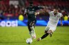 Sevilla's Nemanja Gudelj, right, challenges Arsenal's Bukayo Saka during the Champions League Group B soccer match between Sevilla and Arsenal at the Ramon Sanchez-Pizjuan stadium in Seville, Spain, Tuesday Oct. 24, 2023. (AP Photo/Jose Breton)