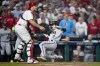 Arizona Diamondbacks' Corbin Carroll scores past Philadelphia Phillies catcher J.T. Realmuto on a single by Gabriel Moreno during the fifth inning in Game 7 of the baseball NL Championship Series in Philadelphia Tuesday, Oct. 24, 2023. (AP Photo/Matt Slocum)