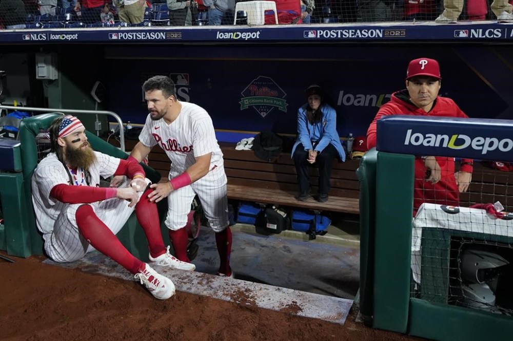 Philadelphia Phillies center fielder Brandon Marsh and designated hitter Kyle Schwarber react after the team's loss to the Arizona Diamondbacks in Game 7 of the baseball NL Championship Series in Philadelphia Tuesday, Oct. 24, 2023. (AP Photo/Matt Slocum)