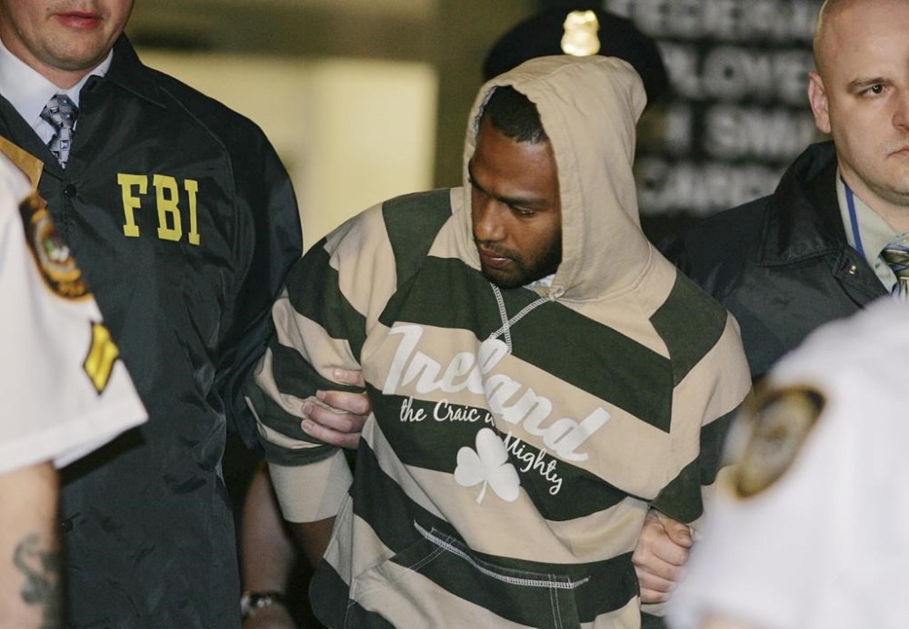 FILE - David Williams, center, is led by police officers from a federal building, May 21, 2009, in New York after being arrested on charges related to a bombing plot with three others in the Bronx. A federal judge in March 2023 freed Williams and two others convicted in a post-9/11 terrorism sting after deeming their lengthy sentences “unduly harsh and unjust.” The judge decried the FBI’s role in radicalizing them in a plot to blow up New York synagogues and shoot down National Guard planes, and reduced their mandatory minimum 25-year prison sentences imposed in 2011 to time served plus 90 days. James Cromitie wasn't part of the compassionate release request and is expected to complete his prison sentence in 2030. (AP Photo/Robert Mecea, File)
