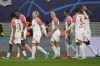 Leipzig's David Raum, centre, celebrates after scoring his side's opening goal during the group G Champions League soccer match between RB Leipzig and Red Star Belgrade at the Red Bull arena stadium in Leipzig, Germany, Wednesday, Oct. 25, 2023. (AP Photo/Matthias Schrader)