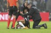 Newcastle's Jacob Murphy receives medical treatment during the Champions League group F soccer match between Newcastle and Dortmund at St. James' Park, in Newcastle, England, Wednesday, Oct. 25, 2023. (AP Photo/Scott Heppell)