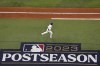 Texas Rangers' Corey Seager watches his home run against the Houston Astros during the third inning in Game 4 of the baseball American League Championship Series Thursday, Oct. 19, 2023, in Arlington, Texas. (AP Photo/Julio Cortez)
